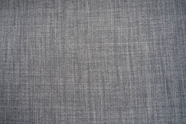 gray background fabric texture. A piece of woolen cloth is neatly laid out on the surface. Weave and textile texture. Dress fabric or for kitchen needs, tablecloth or curtains, close-up. Dash.