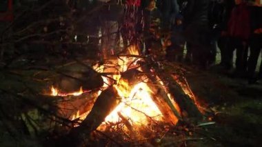 Sremska Mitrovica, January 6, 2022 Burning of the sacred oak tree at the stake in front of a crowd of people. Celebrating Christian Orthodox Christmas. Sparks fly to the believing parishioners