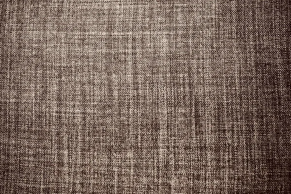 brown background fabric texture. A piece of woolen cloth is neatly laid out on the surface. Weave and textile texture. Dress fabric or for kitchen needs, tablecloth or curtains, close-up. Dash.