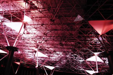 Metal structures under the ceiling. Decorative details of the airport ceiling . Concrete beams, glass windows and metal elements as public building interior design. Abstract avant-garde architecture
