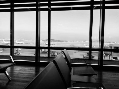 Istanbul Turkey, Sabiha Gokcen Airport Uluslararasi Havalimani 08.04.2022 The waiting room at the airport for stay of passengers. Empty benches. Huge glass windows. View of the runway. Waiting flight