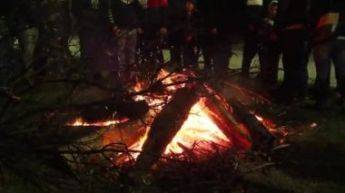 Sremska Mitrovica, January 6, 2022 Burning of the sacred oak tree at the stake in front of a crowd of people. Celebrating Christian Orthodox Christmas. Sparks fly to the believing parishioners