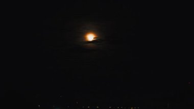 The Moon is the only natural satellite of the Earth. An accelerated video of the moonrise from behind Lake Onega. Evening turns into night. Disk full moon. The moon path is reflected in the water
