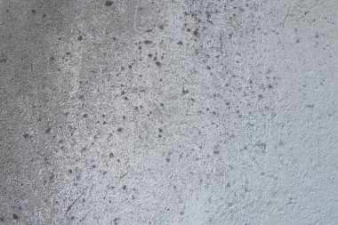 Alçılı duvar dokusu. Beyazlatıcı yüzey. Soyut arkaplan. Retro duvar yapı dokusu inşa etti. Beton duvarda çatlaklar ve tümsekler var. Su bazlı boyayla renklendirilmemiş. Eski püskü alçı..