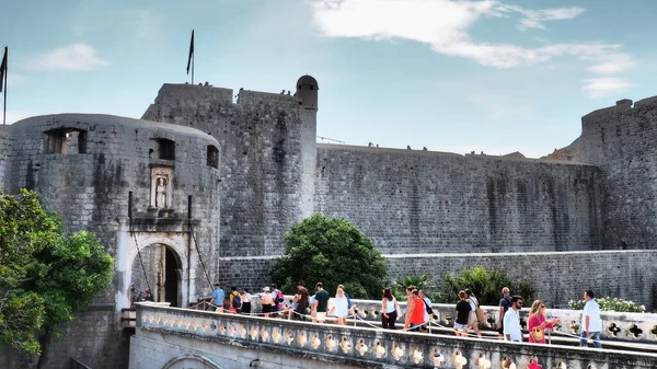 stock image Pile Gate Dubrovnik Croatia August 14 2022 People men and women walk along the stone bridge to the gate of the Old City. Crowd of tourists. Busy entrance. The main entrance to Old Town, busy Pile Gate