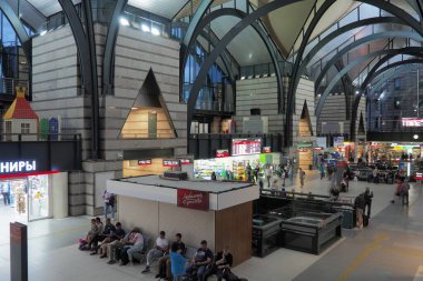 Ladozhsky railway station St. Petersburg, Russia July 15 2022 People are waiting for transport in the waiting room. Train Station. Beautiful beams and vaults on the ceiling of the station. Glass roof