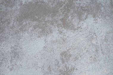 Alçılı duvar dokusu. Beyazlatıcı yüzey. Soyut arkaplan. Retro duvar yapı dokusu inşa etti. Beton duvarda çatlaklar ve tümsekler var. Su bazlı boyayla renklendirilmemiş. Eski püskü alçı..