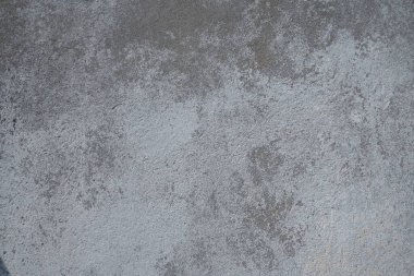 Alçılı duvar dokusu. Beyazlatıcı yüzey. Soyut arkaplan. Retro duvar yapı dokusu inşa etti. Beton duvarda çatlaklar ve tümsekler var. Su bazlı boyayla renklendirilmemiş. Eski püskü alçı..