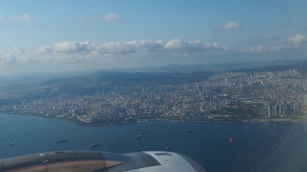 一架客机飞越土耳其首都伊斯坦布尔上空 伊斯坦布尔的房子 飞机引擎 旅行和旅游 从舷窗往外看海滨 博斯普鲁斯海峡 — 图库视频影像