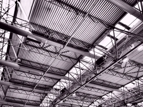 The roof of a hangar, a production hall or a sports hall. Metal structures, beams, supporting elements. Ventilation systems in large halls and rooms. Skylights. Industrial interior