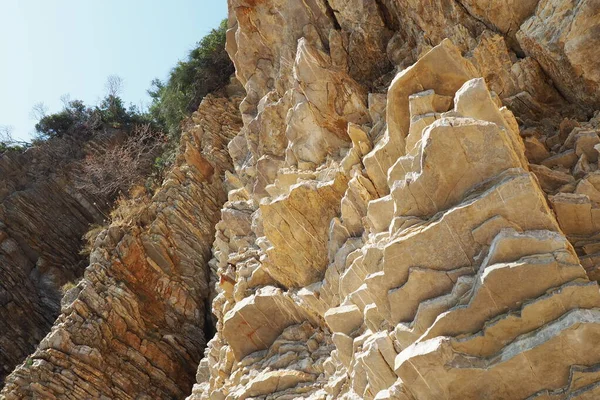 Flysch is a series of marine sedimentary rocks that are predominantly clastic in origin and are characterized by the alternation of lithological layers. Balkans, Montenegro, Budva, Mogren beach.