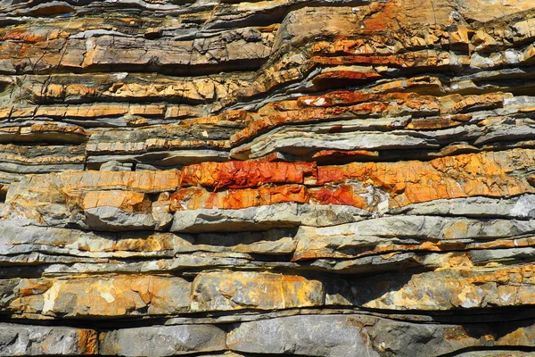 Flysch is a series of marine sedimentary rocks that are predominantly clastic in origin and are characterized by the alternation of lithological layers. Balkans, Montenegro, Budva, Mogren beach.