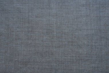 Kumaş dokusu arka planı. Gri dokumalı kumaş. Materyalin doğal buruşuk görünüşü. Üniforma kopyalama alanı arka planı. Pamuk, tuval ya da yünlü ince kumaş yüzeyde eşit olarak serili.