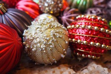 Yılbaşı baloları ve dekorasyonlar kapanıyor. Bir sürü altın dekor, kırmızı, sarı, kahverengi, yeşil, gümüş. Çizgili Noel topları bir demet yalan söyler. Neşeli, güzel, renkli bir arka plan. Tasarım.