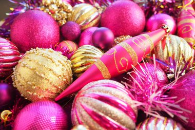 Yılbaşı baloları, süsler ve dekorasyonlar kapanıyor. Altın, pembe, leylak, mor, menekşe. Çizgili Noel topları. Neşeli, güzel, renkli bir arka plan. Ev tatili tasarımı