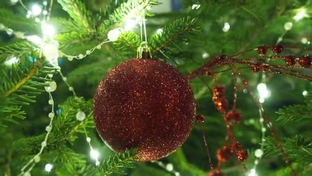 圣诞圣诞树的装饰 红色玻璃易碎 新年快乐圣诞树 漂亮的球在树枝上 在家庭寒假期间 一边摇曳着灯泡一边的茶壶 一边装饰着花环 节日气氛 诺埃尔 — 图库视频影像