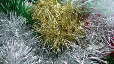 Kırmızı, beyaz, yeşil ve altın rengi Tinsel yağmuru. Noel ağacı, iç mekan ya da parti odası için yılbaşı süslemeleri. Folyo örüyorum. Şenlikli, güzel, parlak arka plan. Tinsel yakın çekim