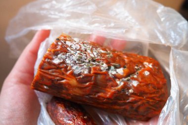 Raw smoked sausage became moldy while it was in a plastic bag. A mold or mould. The dust-like, colored appearance of molds is due to the formation of spores containing fungal secondary metabolites clipart