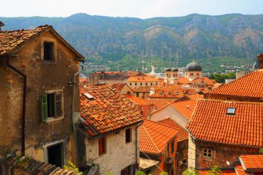 Kotor is a coastal city in Montenegro. Bay of Kotor. Red tiled roofs, mountain and chimneys of a tourist ship. Excursions and tourism. Cathedral of Saint Tryphon. Medieval old towns in the Adriatic. clipart