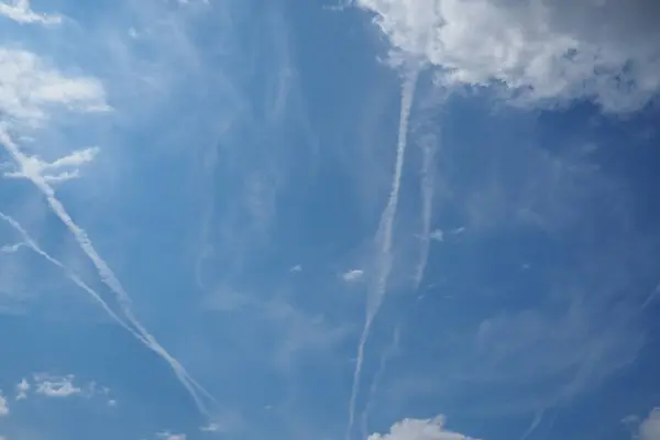 stock image Chemtrail conspiracy theory. Long-lasting condensation trails left in sky by high-flying aircraft are actually chemtrails consisting of chemical or biological agents, sprayed for nefarious purposes.