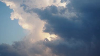 Canlı bir gökyüzü, gün batımının ılık renkleriyle yıkanmış tüylü beyaz bulutları sergiliyor, ufuk boyunca sakin bir ortam yaratıyor, rahatlama ve tefekkür için mükemmel. Akşam şafağı