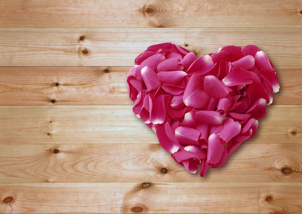 Above view Heart shaped of Pink rose petals on Wooden slat floor with clipping path.