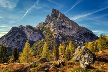 Sass de Stria mountain in the light of the setting sun near Passo Falzarego with cabin lodge clipart