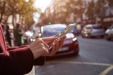 Pedestrian using cellphone while crossing the street.