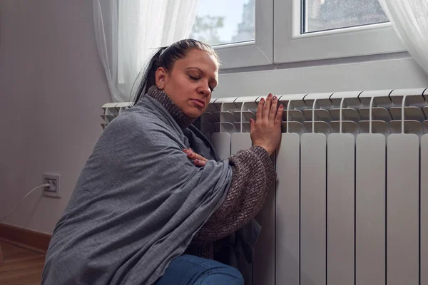 stock image Woman indoors on a chilly winter day, energy and gas crisis, cold room, heating problems.