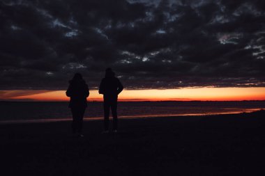 Couple enjoying nice golden hour sunset in nature.