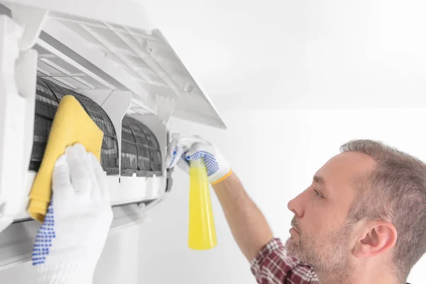 stock image Service guy cleaning and maintaining air condition unit.