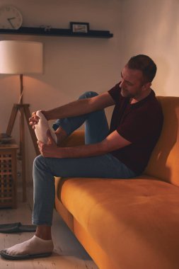 Evinde ayak ağrısı olan bir adam..