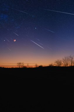 Samanyolu 'nun silueti. Yıldızlı gökyüzü, meteor yağmuru ve hilal ay..