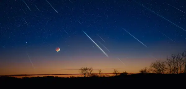 stock image Silhouette of a countryside with Milky Way starry skies, meteor shower and crescent Moon.