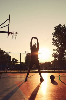 Halk sahasında basketbol topu olan bir adam..