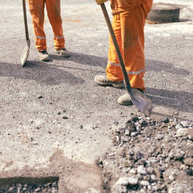 İnşaat işçisi kamu yollarının yeniden inşası üzerinde çalışıyor..