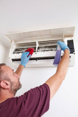 Evdeki havalandırmayı temizleyen ve koruyan adam..