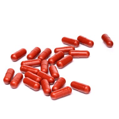 Beyaz arka planda kırmızı haplar var. Kırmızı haplar