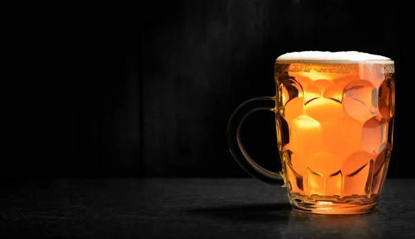 bocal of beer with dark background