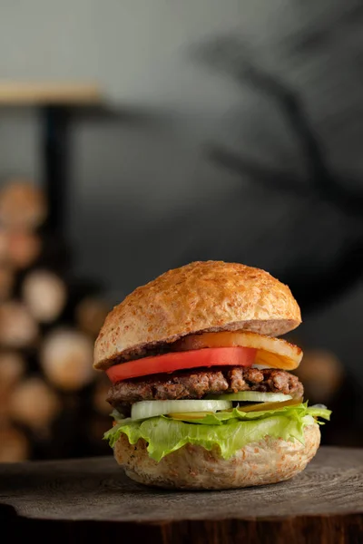 Close up photo of a burger with bacon, cheese and lettuce, photo for a restaurant fast food