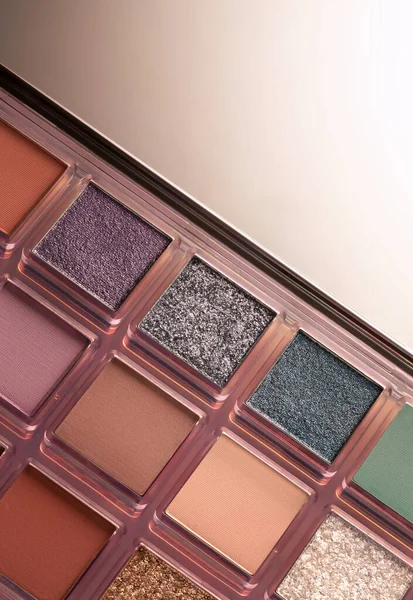 Beautifully lit palette of cosmetic shadows, advertising photography.