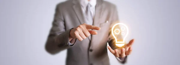 Business man with innovation digital light bulb gear icon. Business engineering idea background.