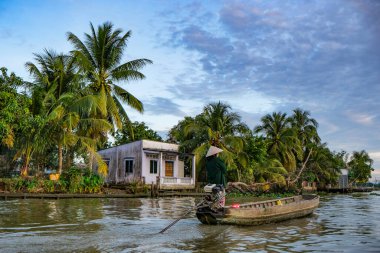 Can Tho, Vietnam - January 4, 2023: A woman sailing a boat in the Mekong River Delta in Can Tho, Vietnam.