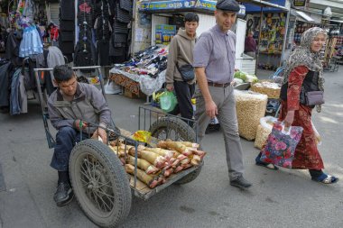 Osh, Kırgızistan - 6 Ekim 2023: Kırgızistan 'daki Jayma Çarşısı' nda inek bacağı satan bir adam.