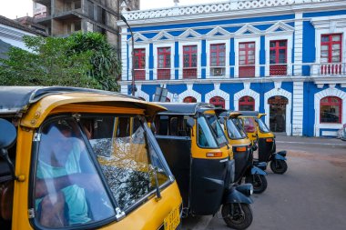 Panaji, India - February 2, 2024: Auto rickshaws stop in front of the Church of the Immaculate Conception in Panaji, Goa, India. clipart