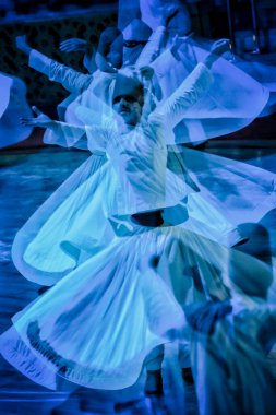 Konya, Turkey - August 18, 2024: Whirling dervishes during a sufi whirling performance in Konya, Turkey. clipart