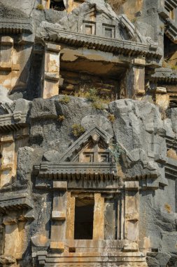 Demre, Turkey - August 24, 2024: Rock-cut tombs in the ruins of Myra Ancient City in Demre, Turkey. clipart