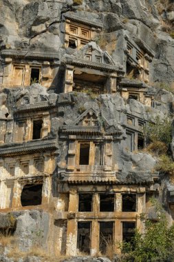 Demre, Turkey - August 24, 2024: Rock-cut tombs in the ruins of Myra Ancient City in Demre, Turkey. clipart