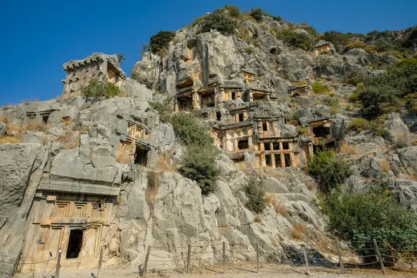 stock image Demre, Turkey - August 24, 2024: Rock-cut tombs in the ruins of Myra Ancient City in Demre, Turkey.