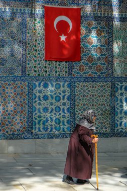 Istanbul, Turkey - September 23, 2024: A woman visiting the Eyup Sultan Mosque and the mausoleum of Abu Ayyub al-Ansari in Istanbul, Turkey. clipart